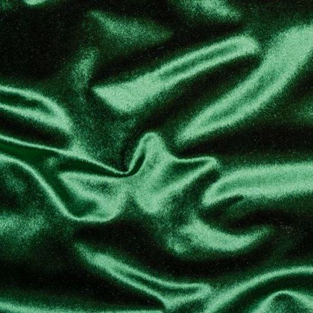 Shiny emerald green fabric with smooth, rippling folds and deep shadows