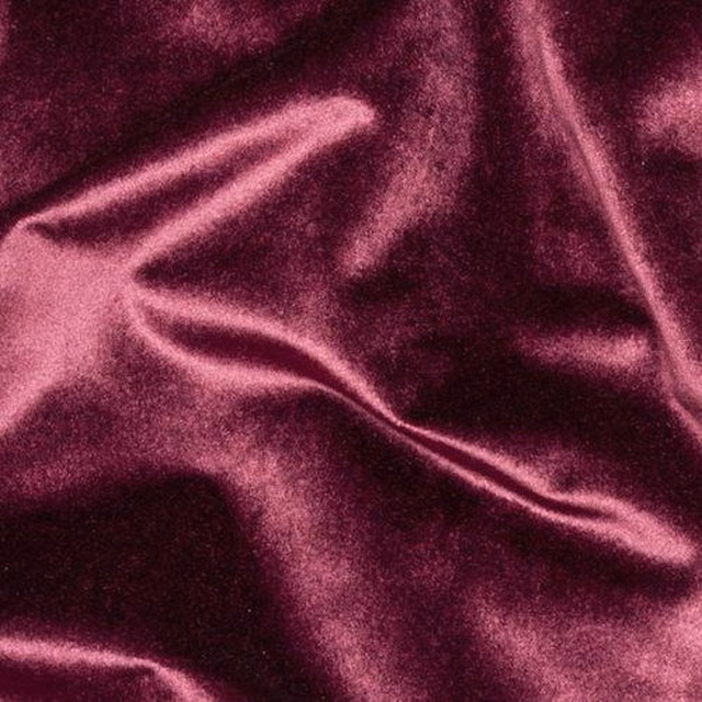 Deep grape-purple velvet fabric with glossy folds and soft sheen