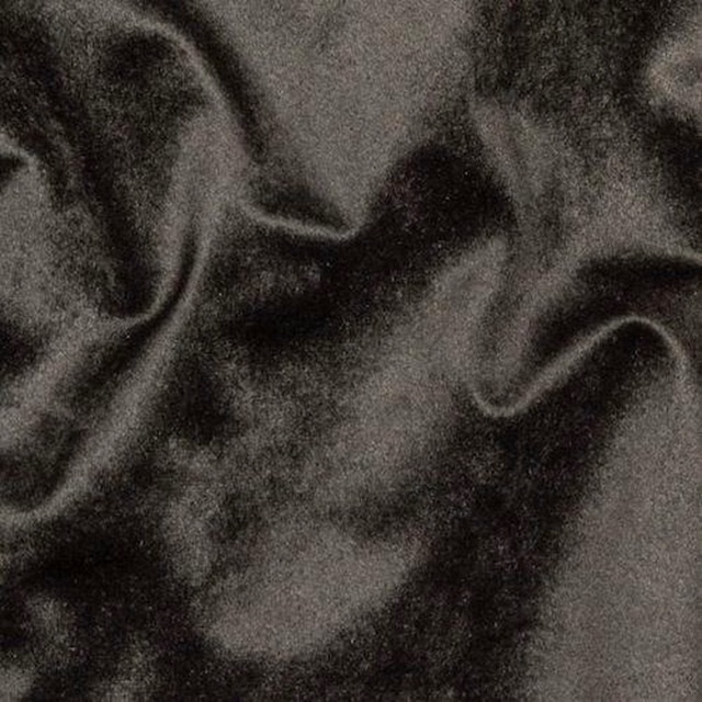 Close-up of smoky black velvet-look fabric with soft highlights and shadowed folds