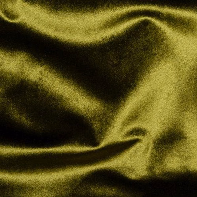 Shimmering sage green fabric with soft folds and deep shadowed sheen