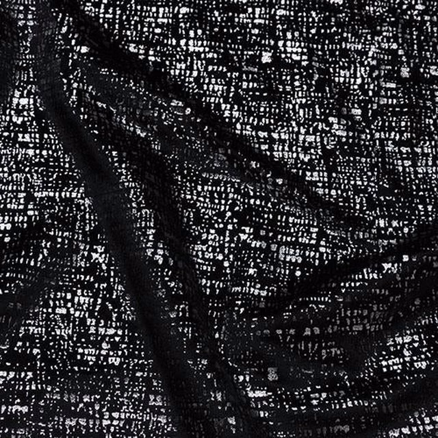 Black speckled woven fabric with white flecks and a textured finish