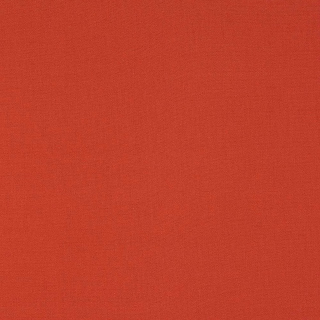 Close-up of warm grapefruit coral plain-weave cotton fabric