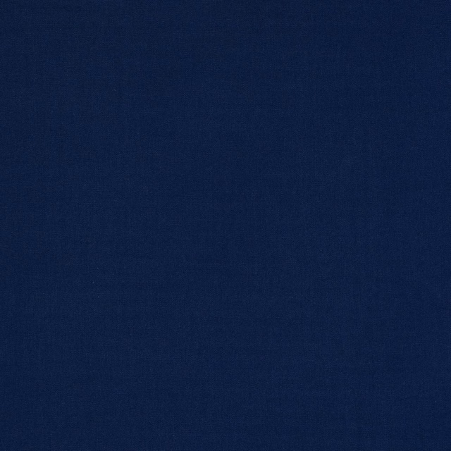 Close-up of deep navy blue plain-woven cotton fabric with fine texture