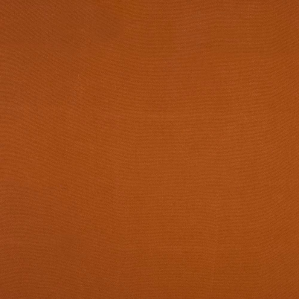 Close-up of plain rust-orange woven cotton fabric with fine texture
