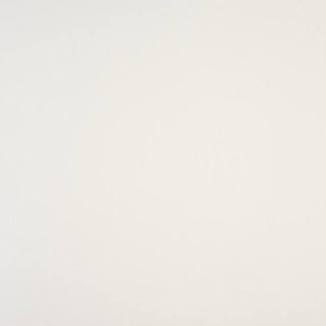 Soft warm white plain cotton fabric swatch with subtle texture