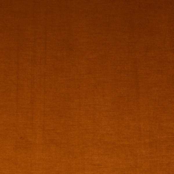 Plain burnt orange fabric swatch with a smooth woven texture and darker top edge