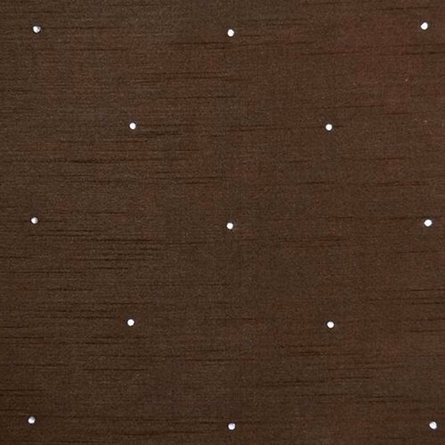 Close-up of rich mocha brown woven fabric with small scattered white dot motif