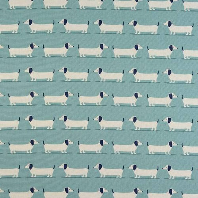 Repeated dachshund motif on soft duck egg blue cotton with navy and white dogs