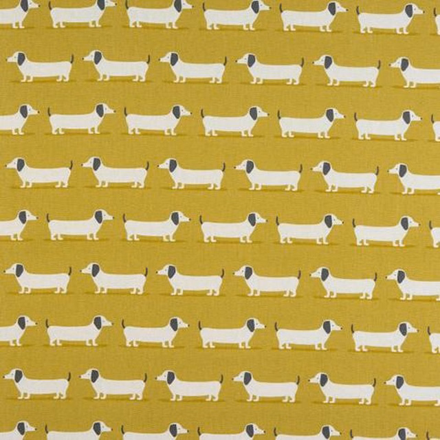 Rows of white dachshund motifs on a muted ochre cotton ground