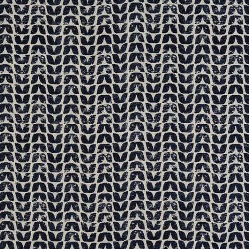 Close-up of small indigo geometric motifs on a pale woven fabric