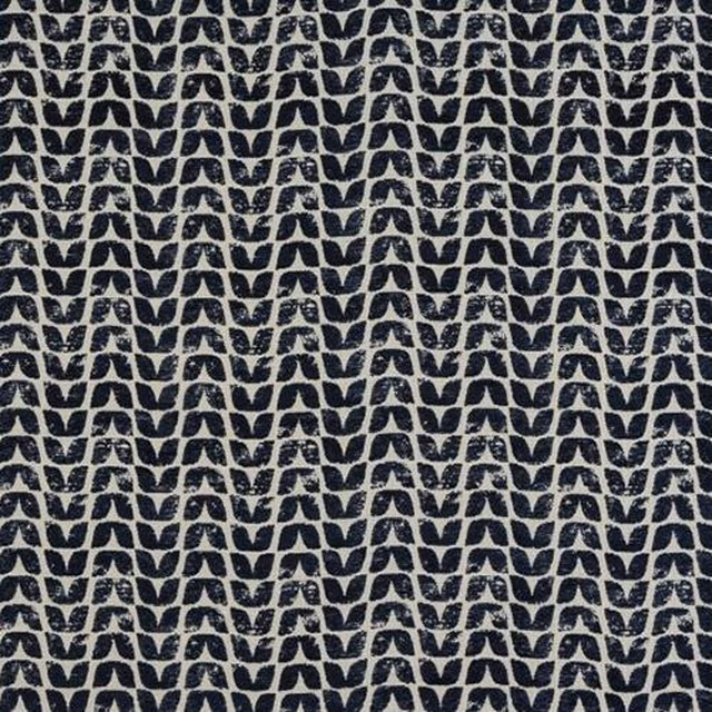 Close-up of small indigo geometric motifs on a pale woven fabric