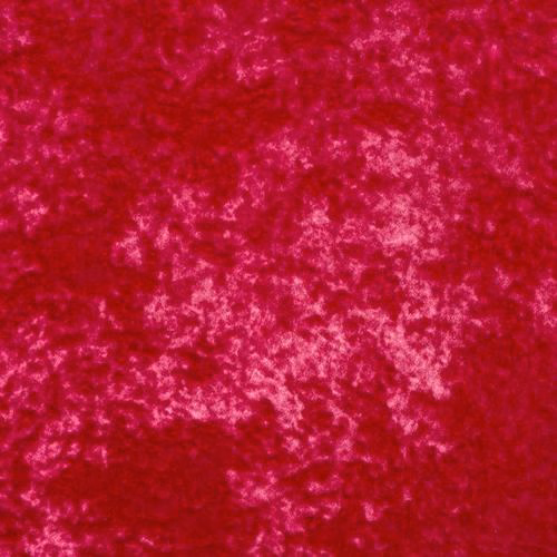 Close-up of vivid fuchsia pink marbled velour with soft lighter highlights