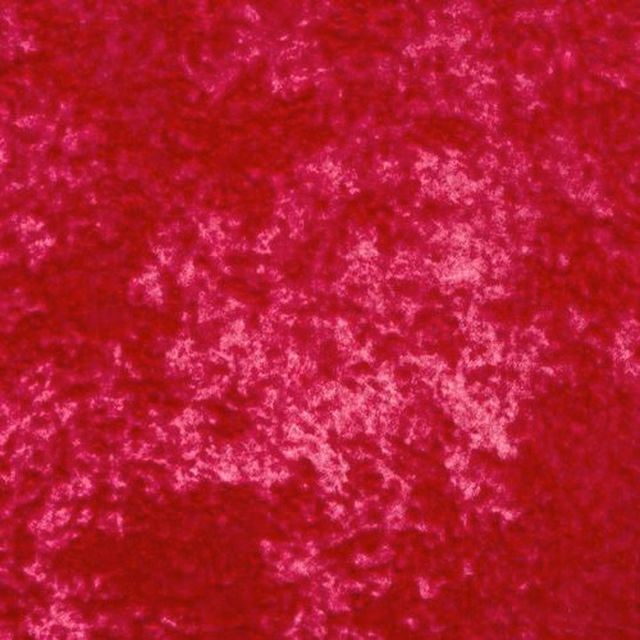 Close-up of vivid fuchsia pink marbled velour with soft lighter highlights