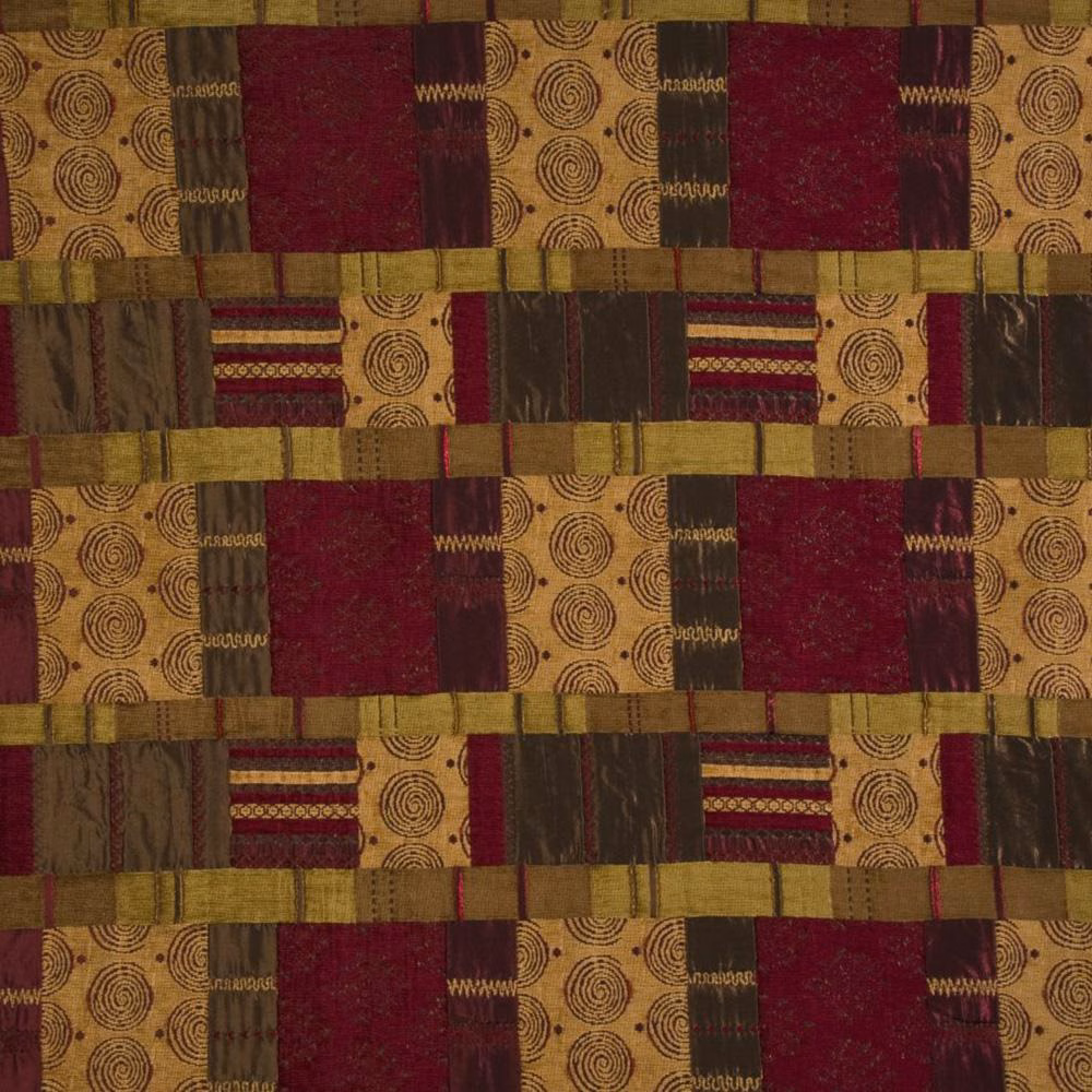 Patchwork patterned fabric swatch in plum, gold and olive tones with circular motifs