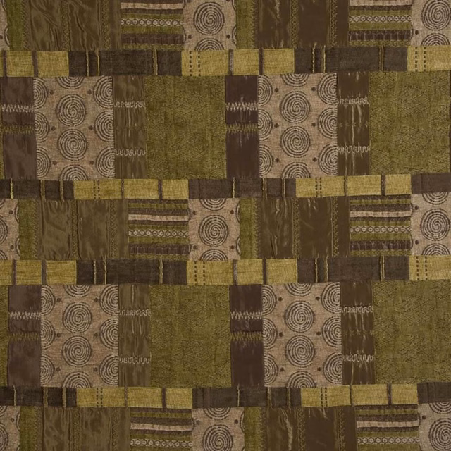 Patchwork woven fabric in tan, olive and brown with spiral and stripe motifs