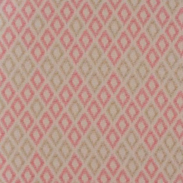 Pink diamond geometric fabric on a warm beige ground, shown as a close-up swatch.