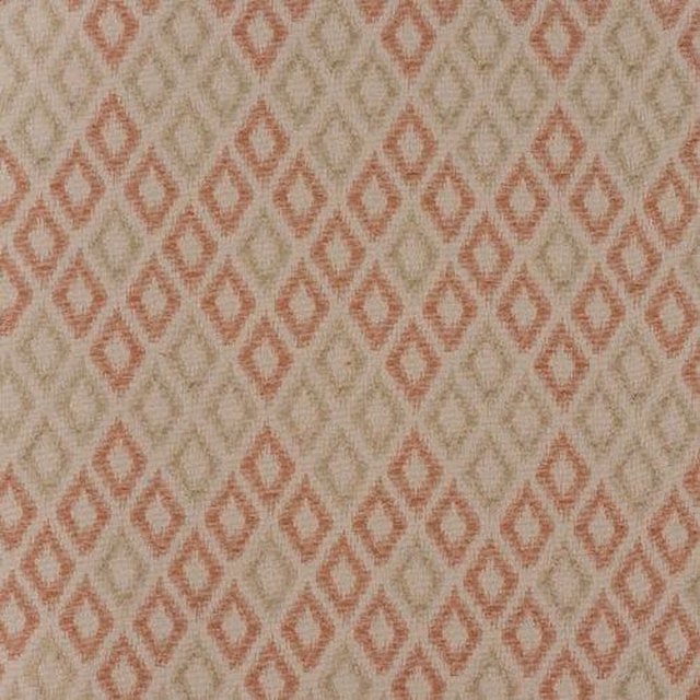 Close-up of beige woven fabric with muted coral diamond geometric pattern