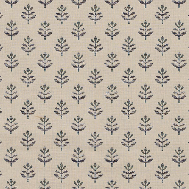 Small navy botanical motif on a pale woven fabric ground