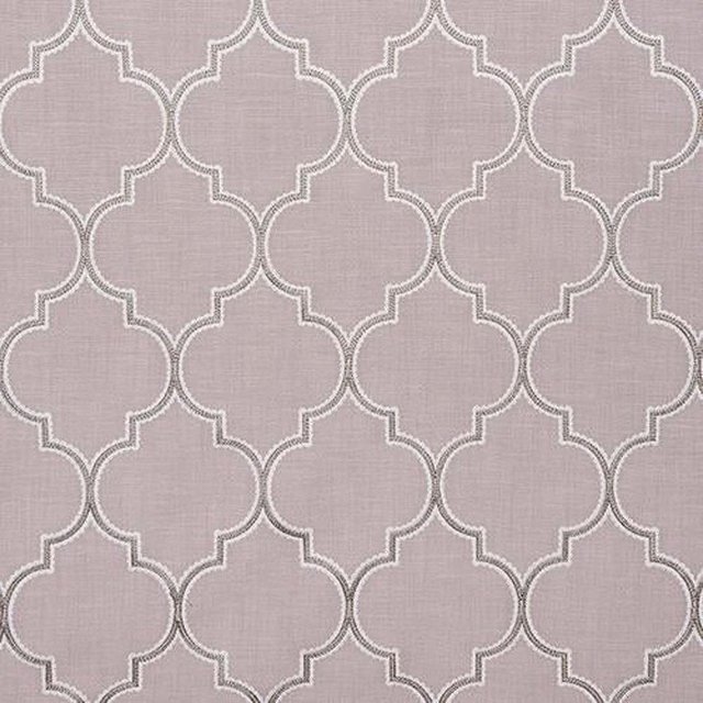 Soft blush pink woven fabric with pale scalloped geometric trellis pattern