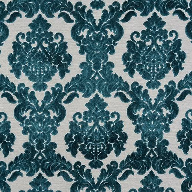 Teal damask upholstery fabric on an ivory ground with a plush textured look