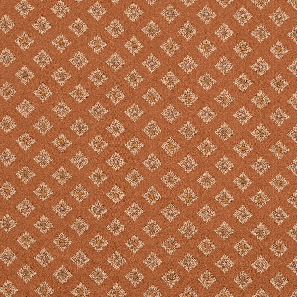 Copper orange woven fabric with small cream diamond motifs and subtle coloured centres
