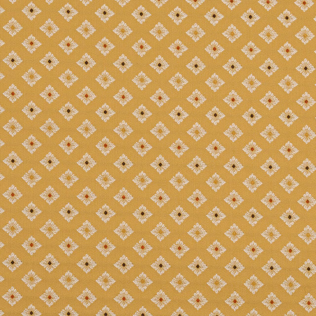 Mustard-gold woven fabric with small ivory diamond motifs and tiny dark centres