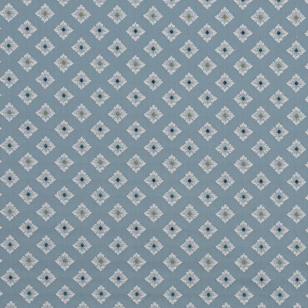 Soft dusty blue fabric with small ivory diamond motif repeat