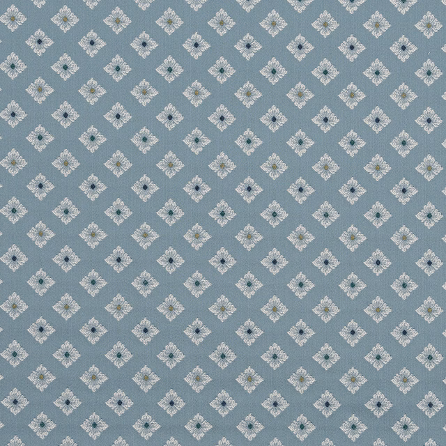 Soft dusty blue fabric with small ivory diamond motif repeat