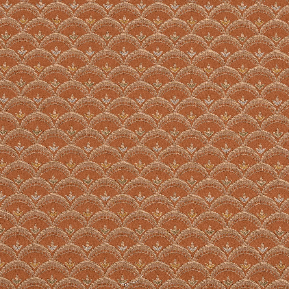 Copper orange woven fabric with repeating scalloped fan motif