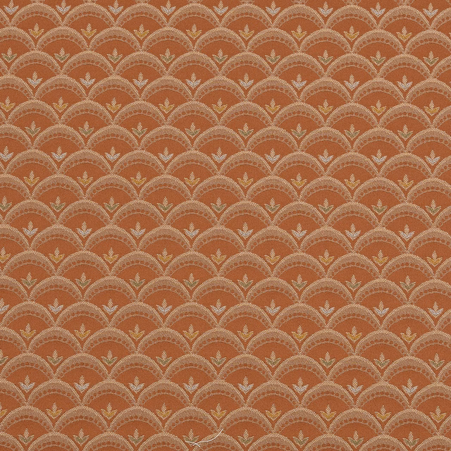 Copper orange woven fabric with repeating scalloped fan motif