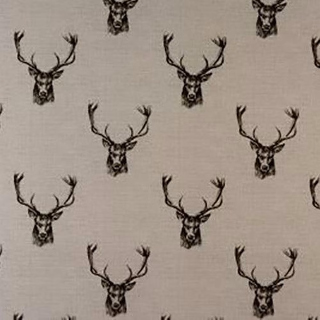 Charcoal stag head motif on pale grey cotton fabric swatch