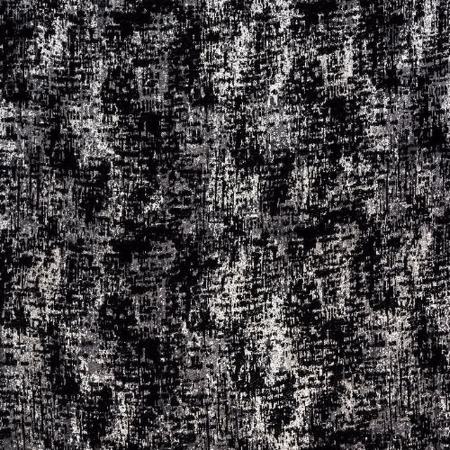 Close-up swatch of mottled charcoal black and grey textured fabric