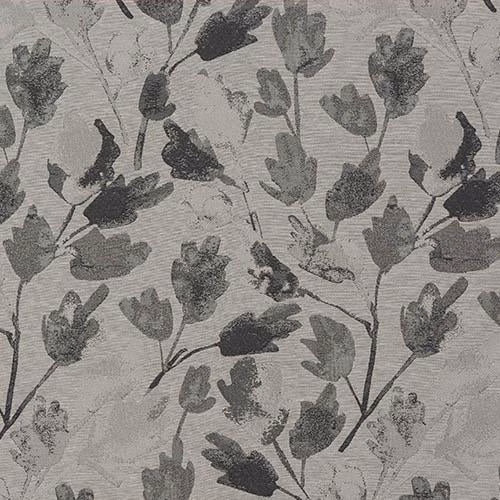 Close-up of charcoal grey leaf motif on a pale woven fabric