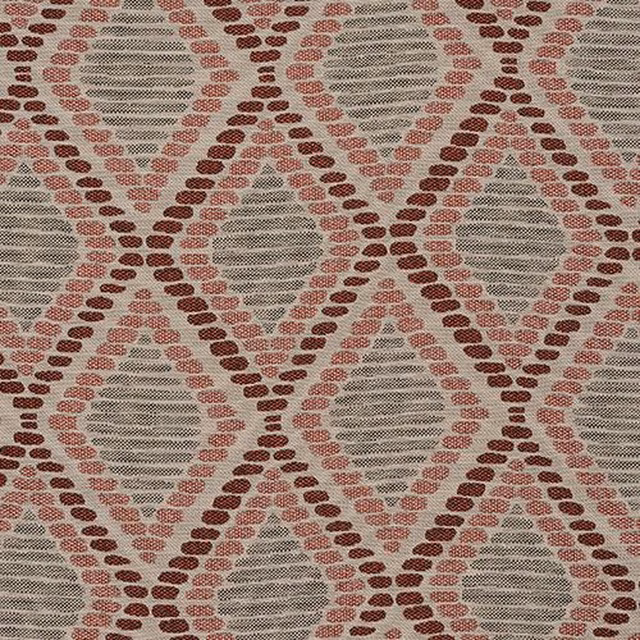 Close-up of geometric woven fabric with brick red diamonds and sage ovals