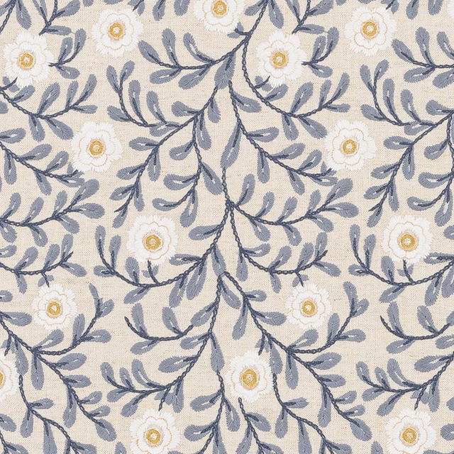 Blue-grey trailing floral fabric with white blooms and gold centres on a pale ground