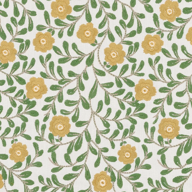Embroidered floral fabric with jade green leaves and soft gold blooms on a pale ground