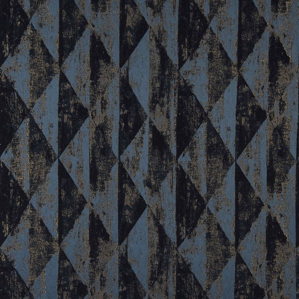 Close-up of geometric teal-blue fabric with black shapes and metallic flecks