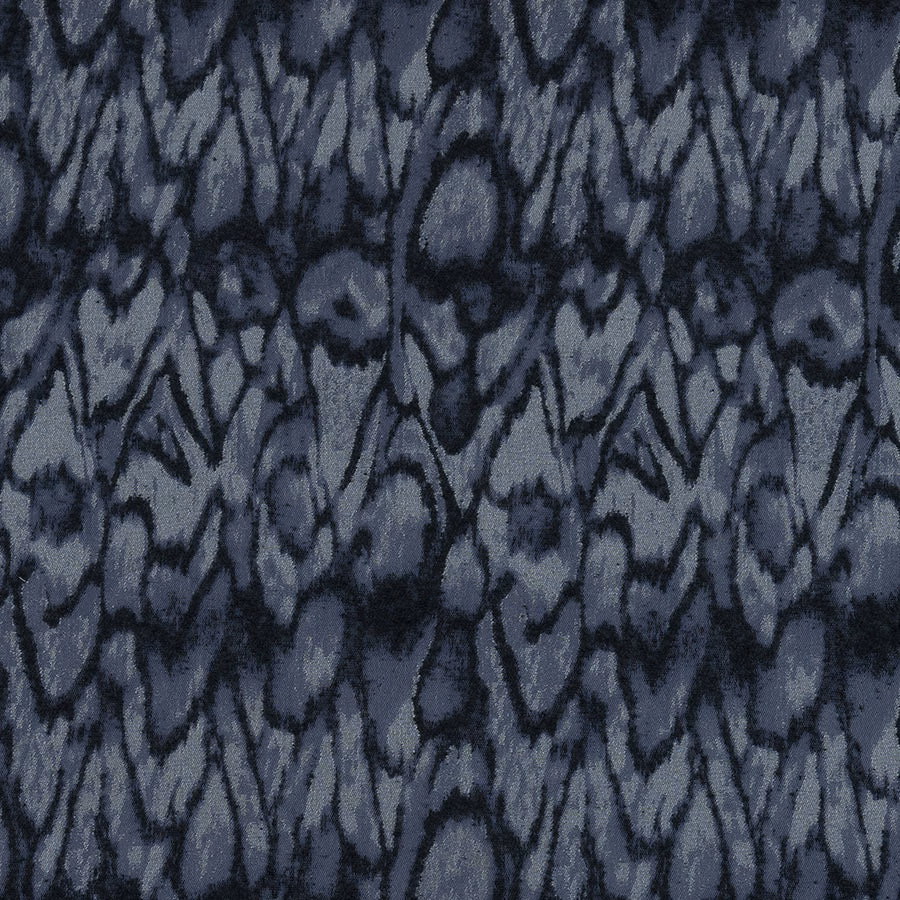 Abstract indigo and slate-blue woven fabric with dark charcoal markings