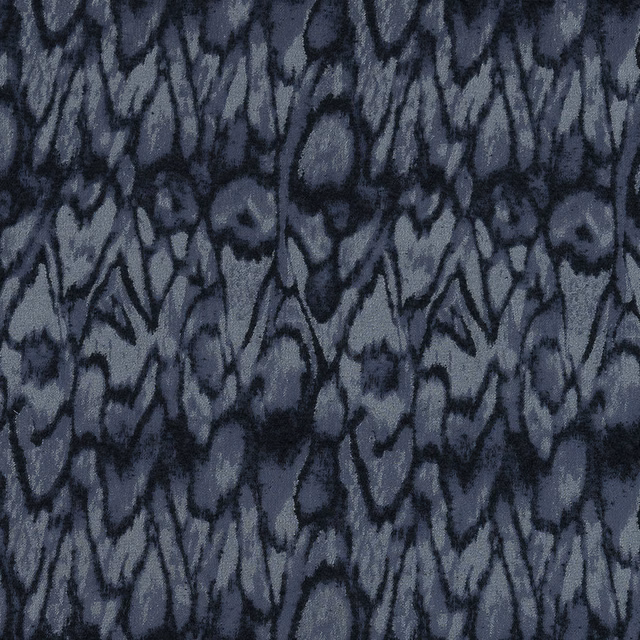 Abstract indigo and slate-blue woven fabric with dark charcoal markings