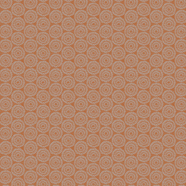 Burnt orange geometric fabric with small rosette repeat and pale circular detail
