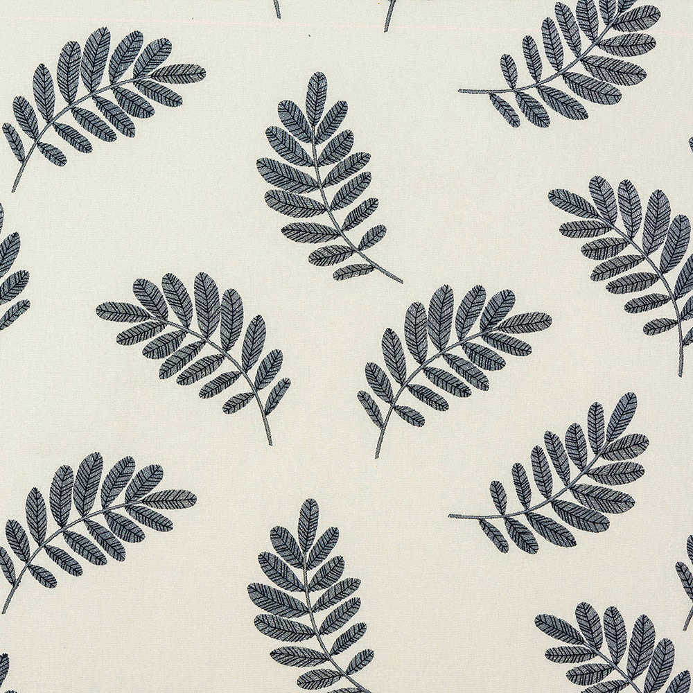 Cream cotton fabric with scattered slate-blue botanical leaf sprigs