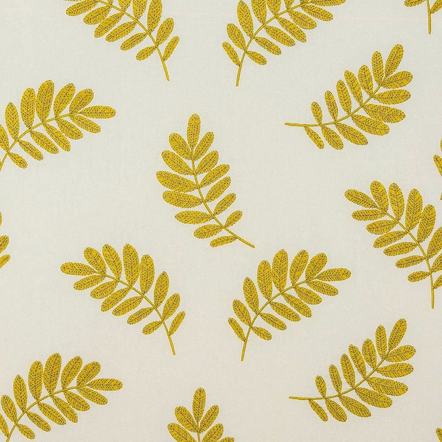 Ochre yellow leaf print on a pale cotton ground