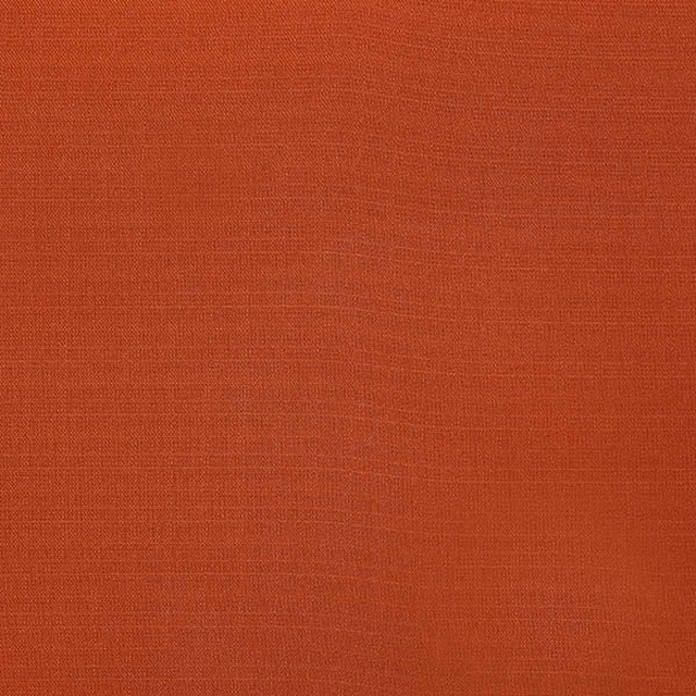 Warm terracotta plain woven fabric swatch with fine textured surface