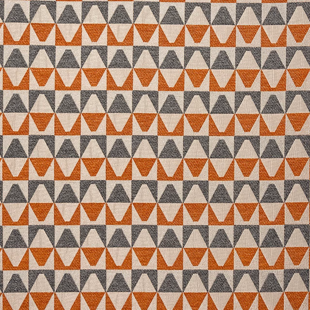 Geometric cotton fabric with burnt orange and charcoal triangular motifs on a pale ground
