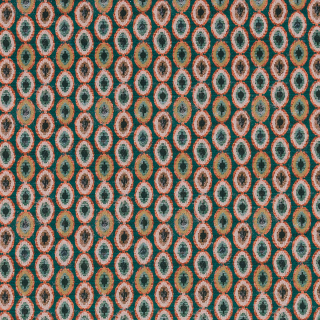 Close-up of Shiraz Jade fabric showing small teal and coral oval motifs on a textured ground.