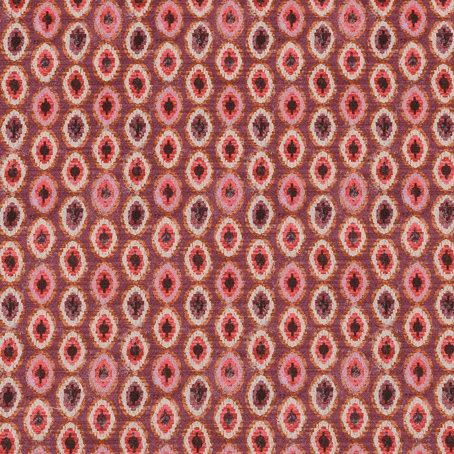 Close-up of Shiraz Rosso woven oval pattern in rose, berry and plum tones