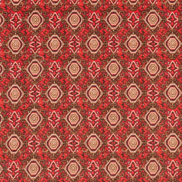 Close-up of Tabriz Rosso fabric showing red geometric medallions with beige and brown details
