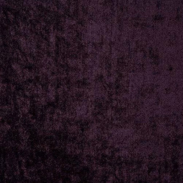 Close-up of deep grape purple velvet with a soft, mottled sheen