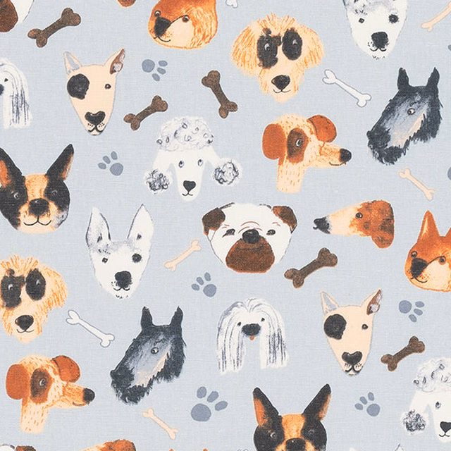 Seafoam blue cotton fabric with painted dog faces, bones and paw prints
