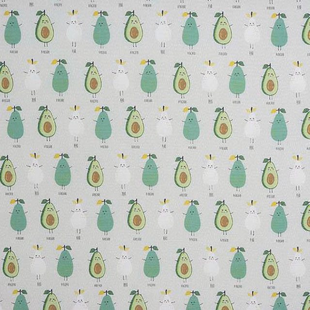 Pale ground PVC table cover with scattered avocado motifs in soft green